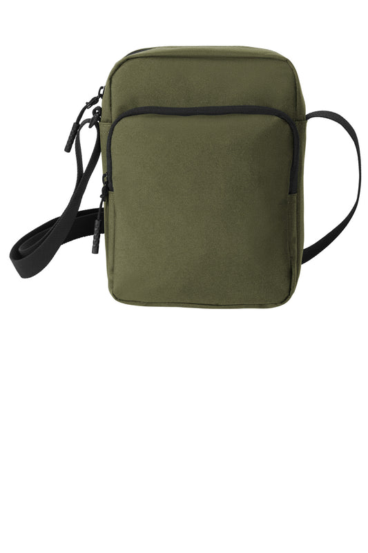 Green crossbody bag with a strap on a white background