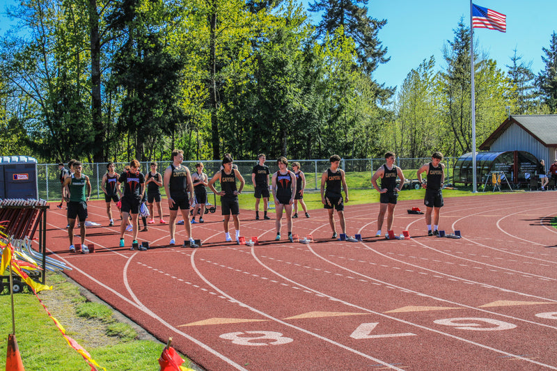 Track and field team lined up on the track